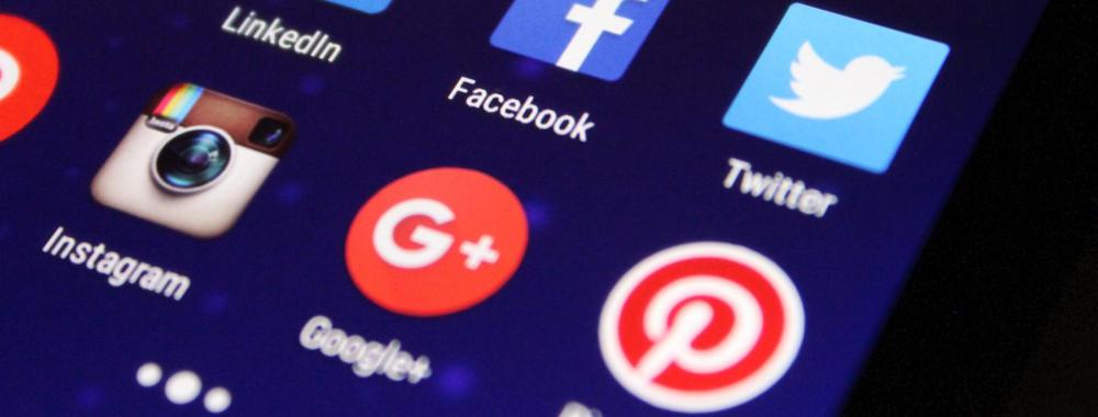 A phone screen, with YouTube, Tumblr, Vine, LinkedIn, Facebook, Twitter, Instagram, and Google Plus icons visible.